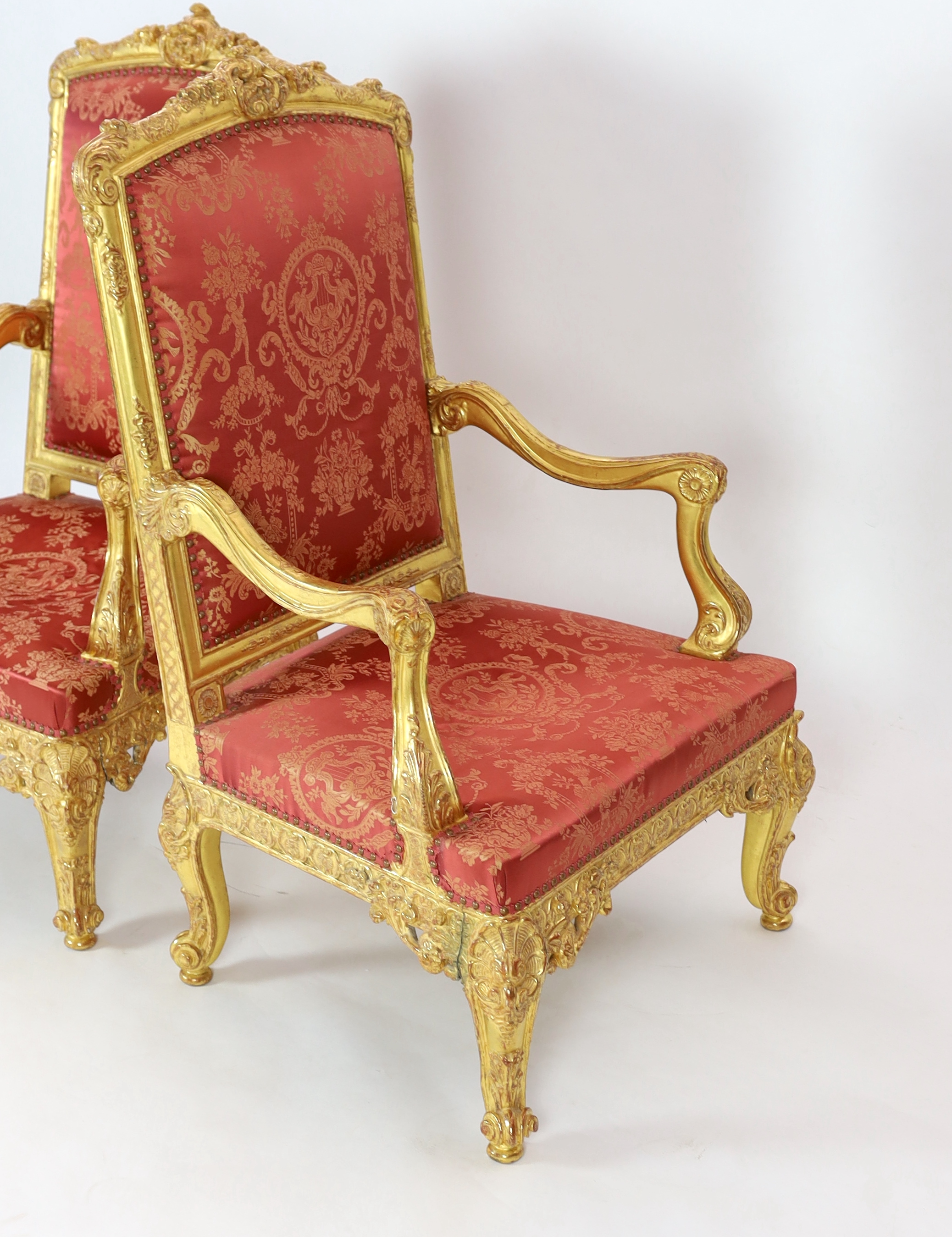 A pair of Louis XV style carved giltwood fauteuils Please note this lot attracts an additional import tax of 5% on the hammer price